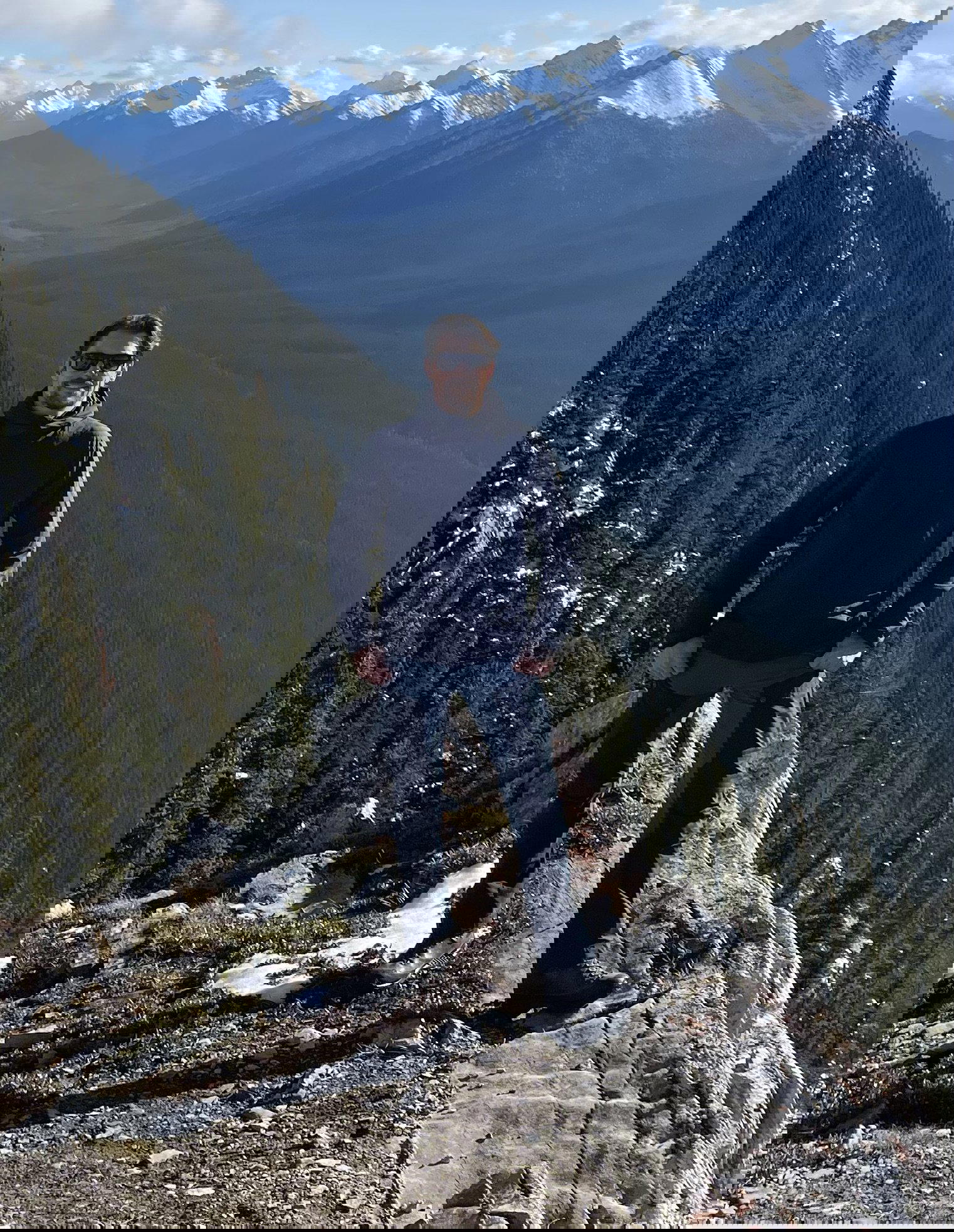 Stefan standing on a mountain top in Banff, Canada