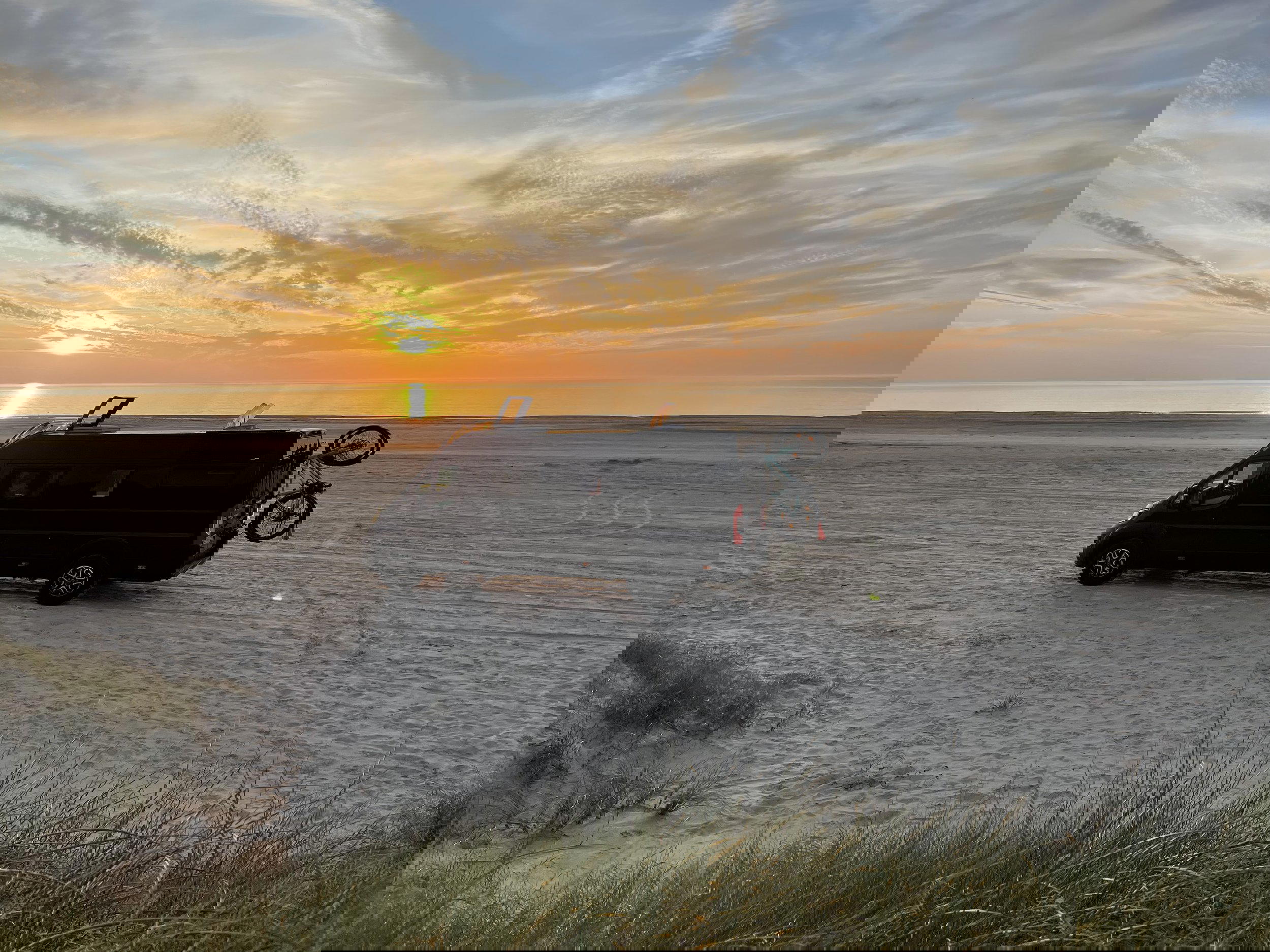 Our van Wilma parked at a Danish beach during sunrise