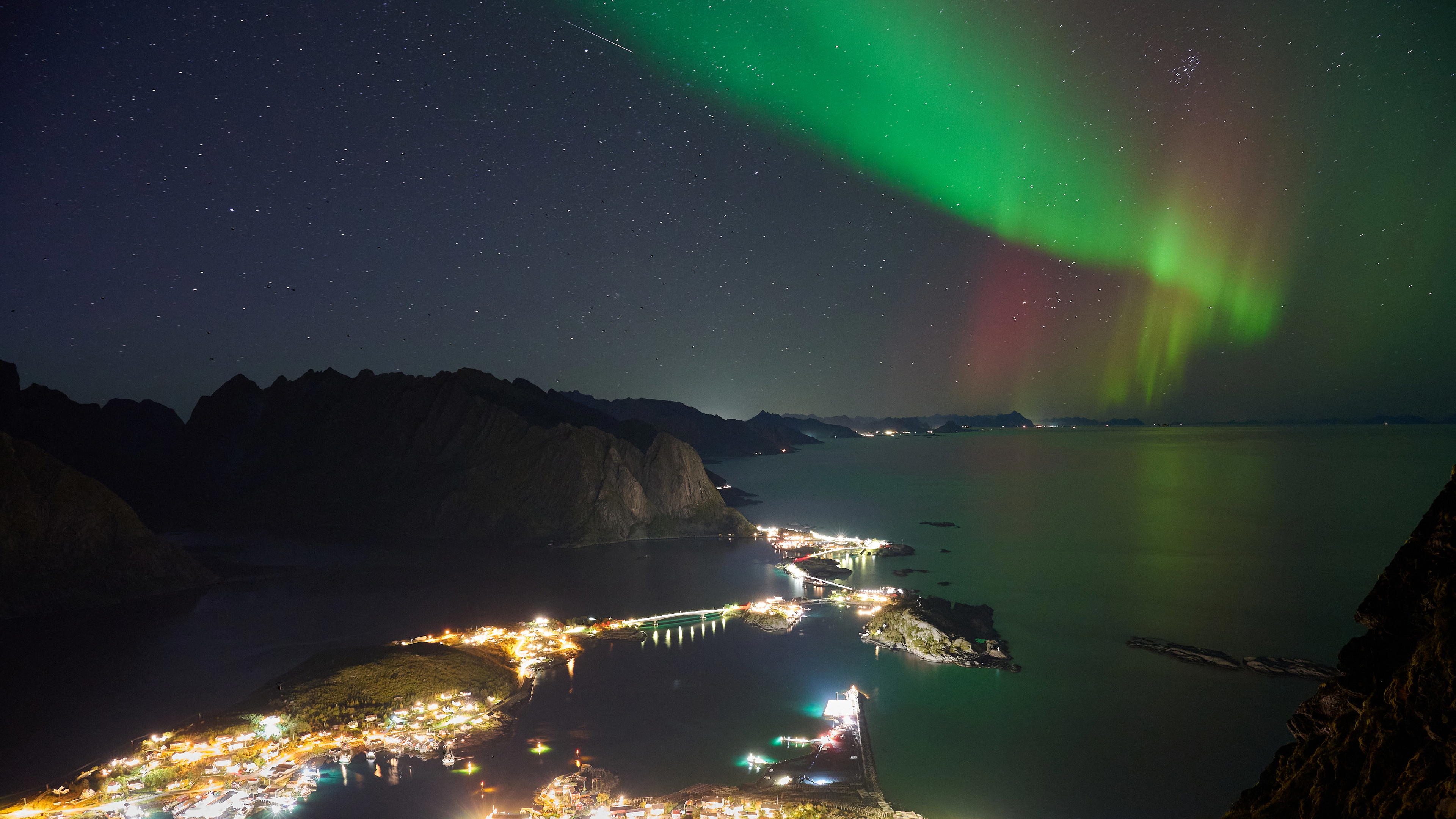 View of the aurora borealis above the village of Reine in Lofoten, Norway